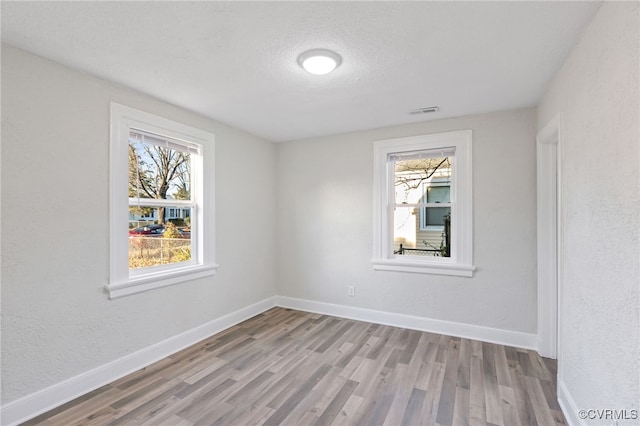 spare room with light wood-type flooring