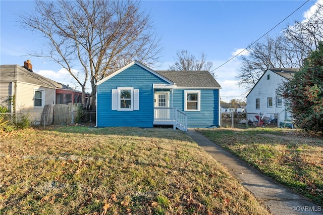 bungalow-style home with a front lawn