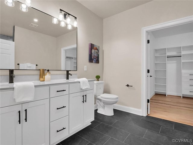 bathroom with toilet, vanity, and hardwood / wood-style flooring