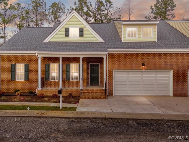 view of front of home with covered porch and a garage