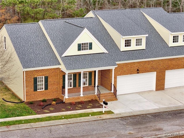 view of front of home featuring a porch and a garage