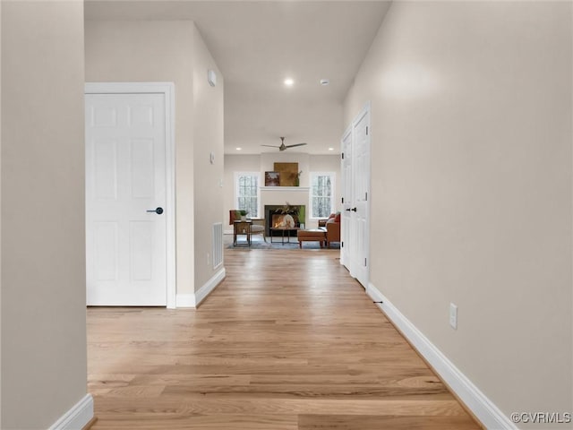 hall with light hardwood / wood-style floors