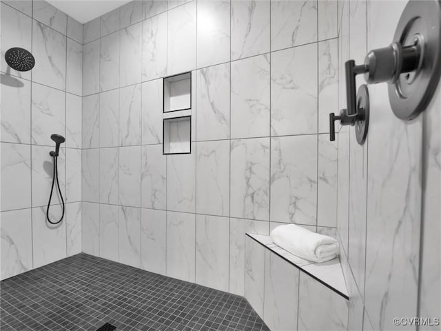 bathroom with tiled shower