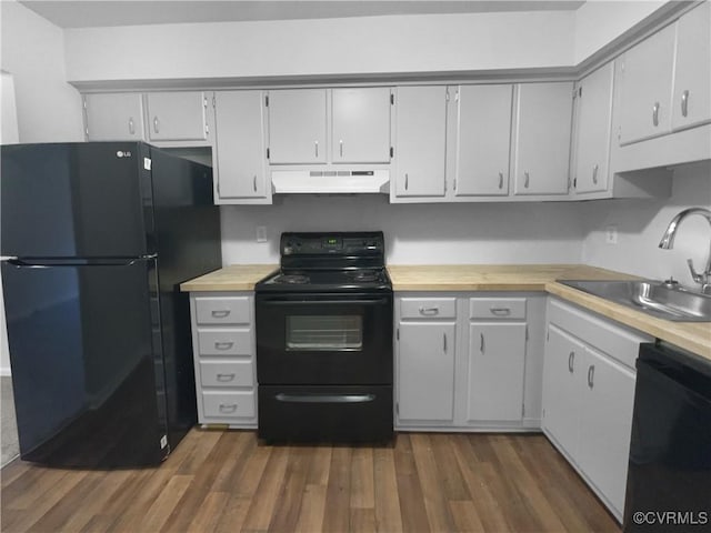 kitchen featuring black appliances, dark hardwood / wood-style flooring, sink, and wooden counters