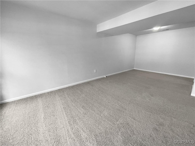 unfurnished room featuring dark colored carpet