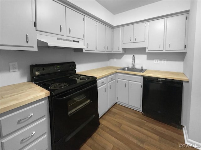 kitchen featuring sink, dark hardwood / wood-style floors, white cabinetry, and black appliances