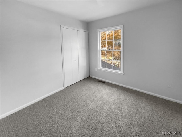 unfurnished bedroom with a closet and carpet floors