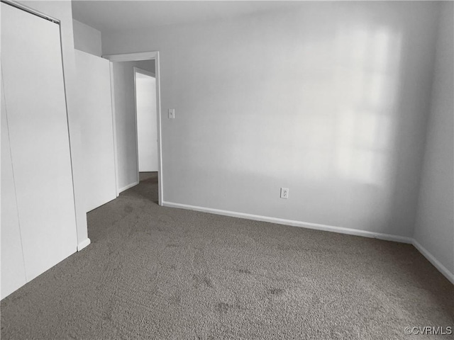 empty room featuring dark carpet