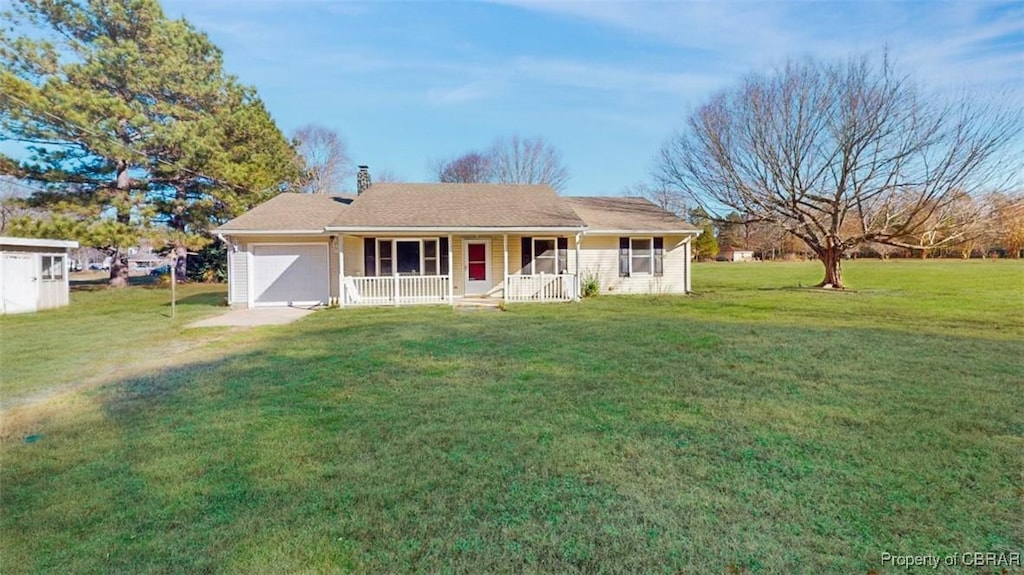 ranch-style house with covered porch, a garage, and a front lawn