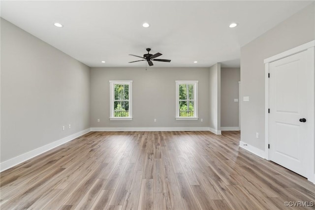 empty room with light hardwood / wood-style flooring and ceiling fan