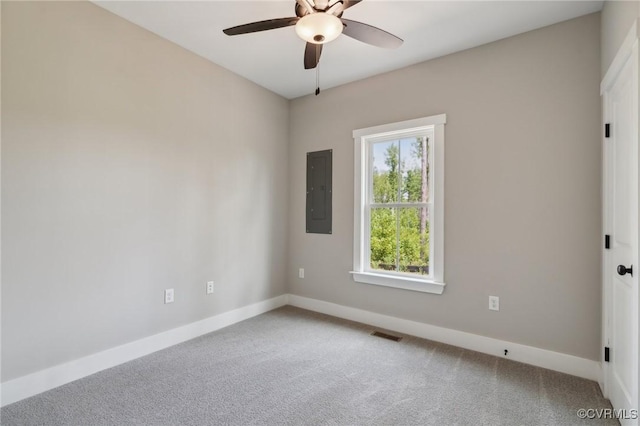 carpeted empty room with ceiling fan and electric panel