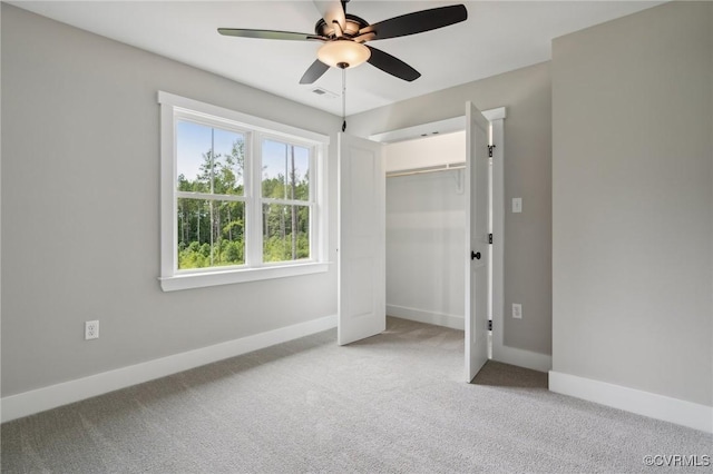 unfurnished bedroom featuring ceiling fan, light carpet, and a closet