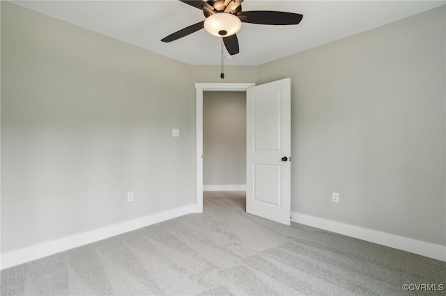 empty room with ceiling fan and light carpet