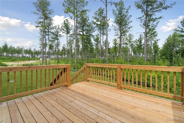 wooden terrace featuring a yard