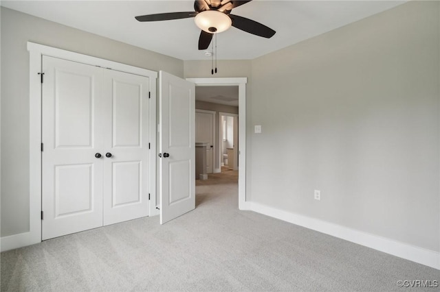 unfurnished bedroom with light carpet, a closet, and ceiling fan