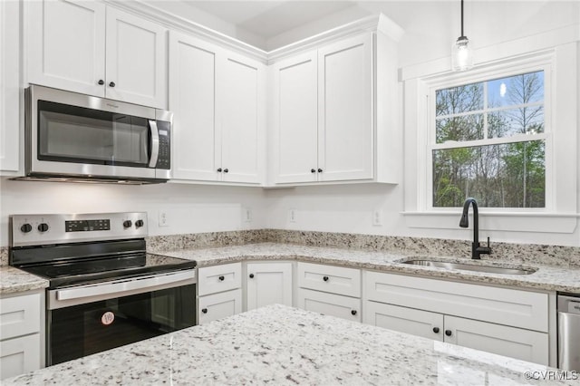 2467 Judes Ferry Rd, Powhatan, VA 23139 - kitchen with white cabinets, a sink, light stone countertops, hanging light fixtures, and appliances with stainless steel finishes