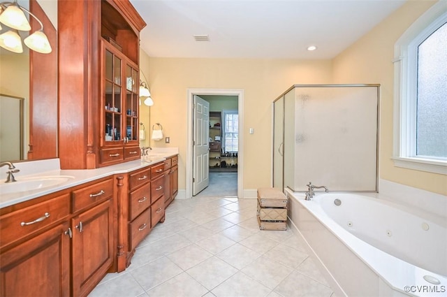 full bathroom with a tub with jets, double vanity, a stall shower, a sink, and tile patterned flooring