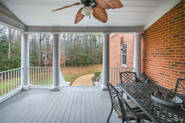 deck with outdoor dining space and ceiling fan