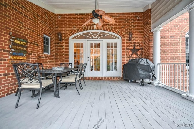 deck with outdoor dining space, french doors, and a grill