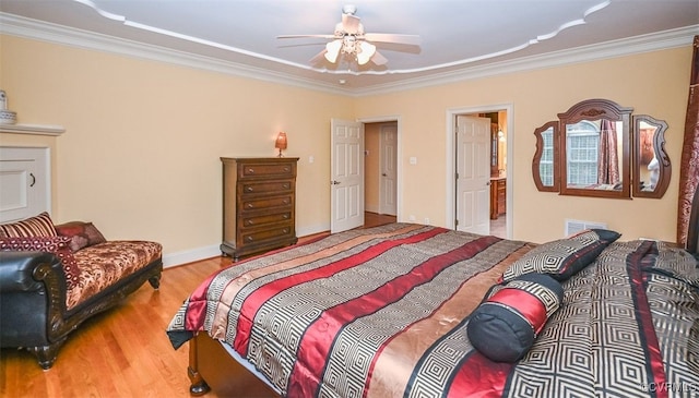 bedroom featuring visible vents, wood finished floors, a ceiling fan, and ornamental molding