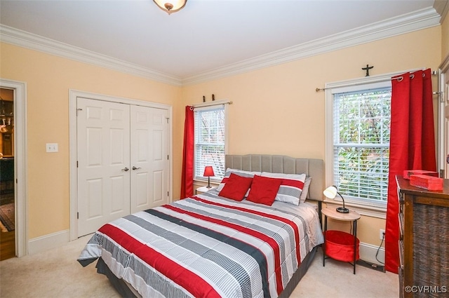 carpeted bedroom featuring a closet, crown molding, and baseboards