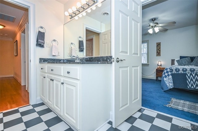 bathroom with tile patterned floors, visible vents, vanity, and ceiling fan