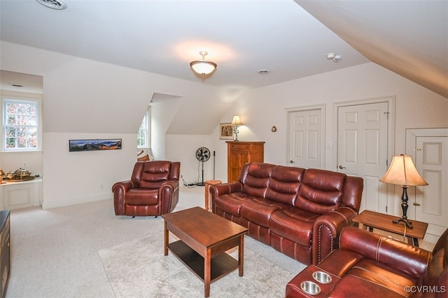 carpeted living room featuring vaulted ceiling and baseboards