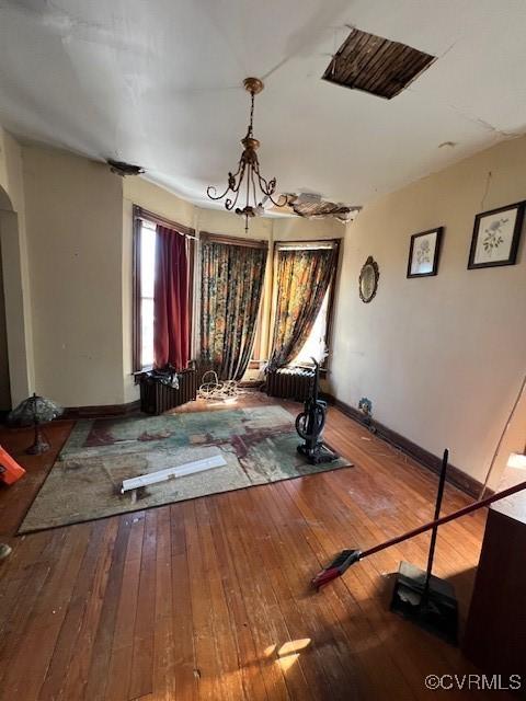 interior space featuring wood-type flooring and baseboards