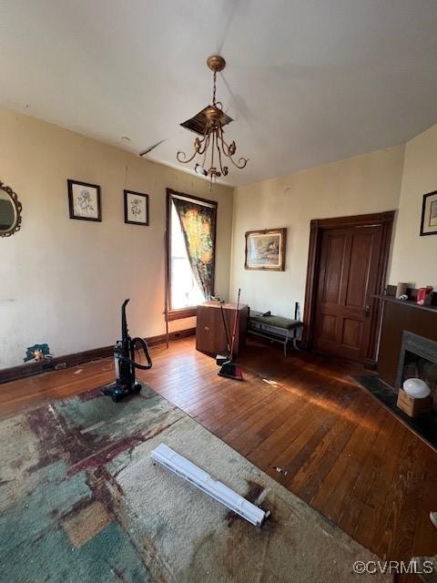 workout room featuring hardwood / wood-style floors and a fireplace