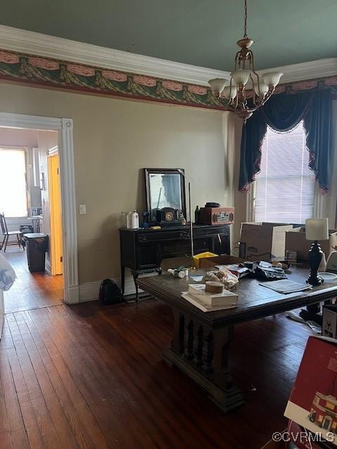 office area with a chandelier, ornamental molding, hardwood / wood-style flooring, and baseboards