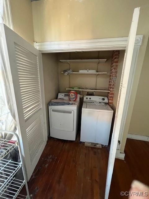 washroom with laundry area, washer and clothes dryer, and wood finished floors