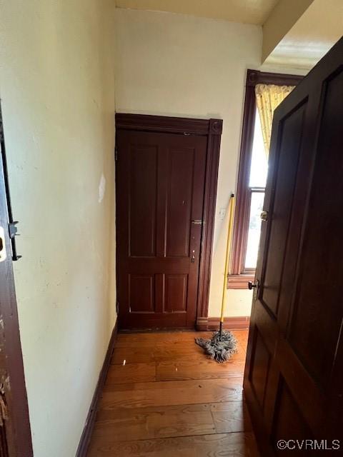 hall with hardwood / wood-style flooring and baseboards