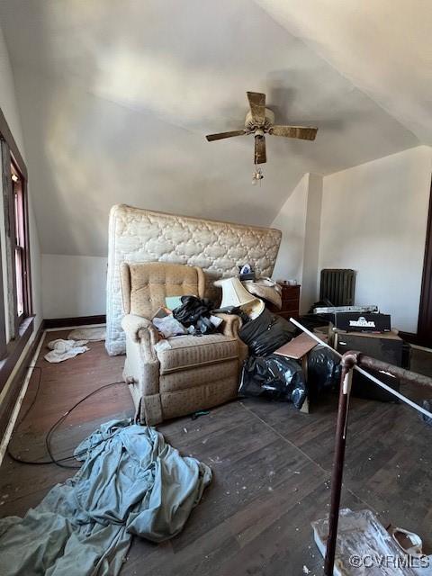 interior space featuring a ceiling fan, lofted ceiling, and wood finished floors