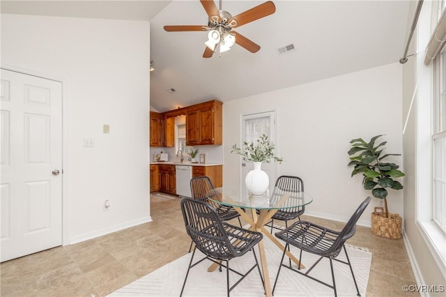 tiled dining space featuring ceiling fan and lofted ceiling