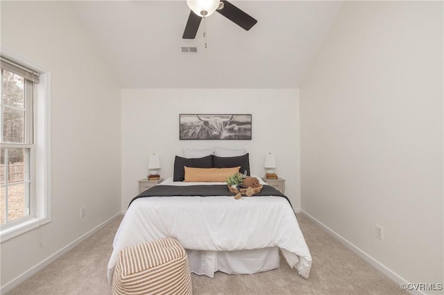 carpeted bedroom with multiple windows, lofted ceiling, and ceiling fan