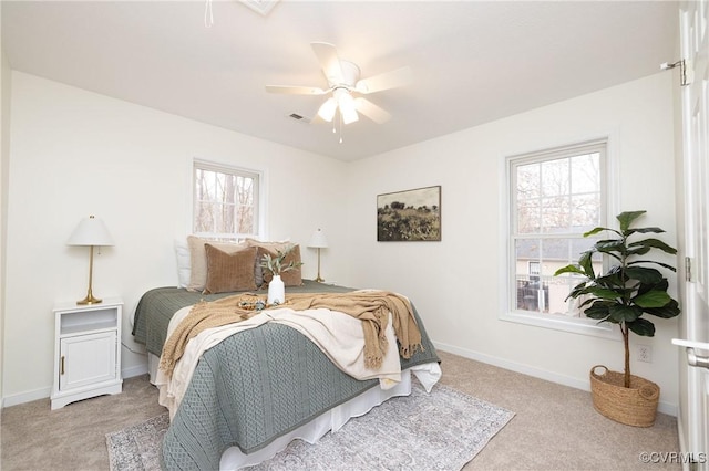 bedroom featuring ceiling fan and light carpet