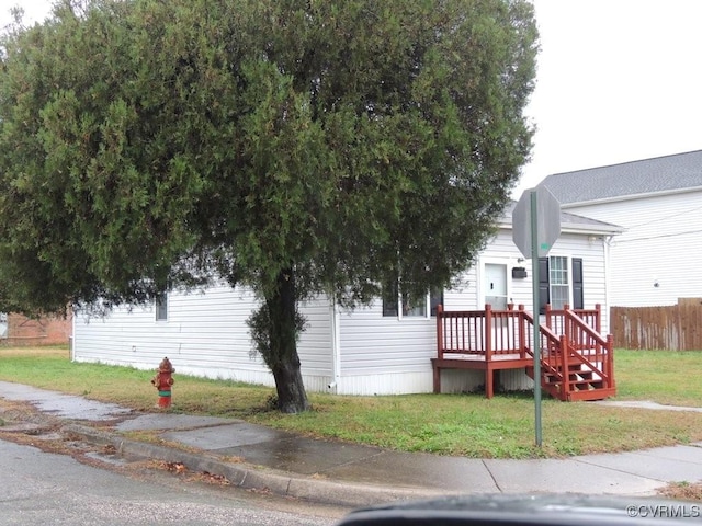 view of side of home featuring a lawn