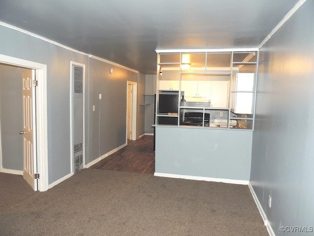 kitchen featuring dark carpet, white cabinets, refrigerator, a peninsula, and a heating unit