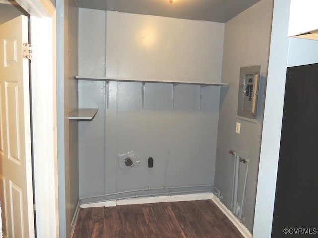 laundry area featuring electric panel, wood finished floors, and baseboards