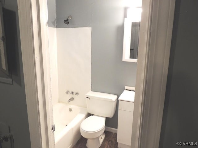 bathroom featuring toilet, shower / bathtub combination, vanity, wood finished floors, and baseboards