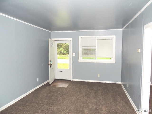 foyer with dark colored carpet and baseboards
