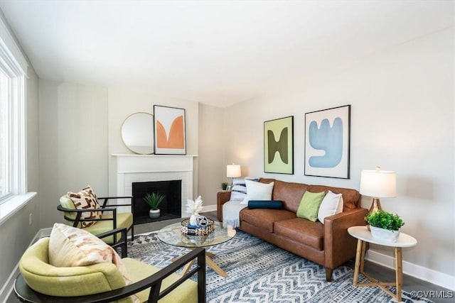 living room with hardwood / wood-style flooring and a brick fireplace