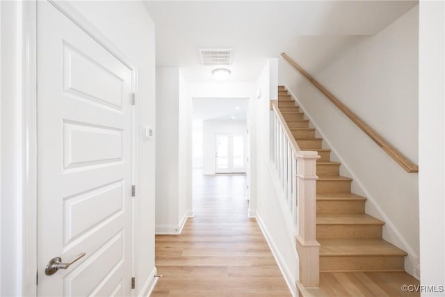 staircase with hardwood / wood-style floors