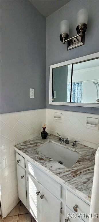 bathroom featuring vanity, tile walls, and tile patterned flooring