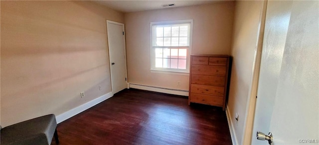 unfurnished room featuring dark wood finished floors, baseboards, visible vents, and a baseboard radiator