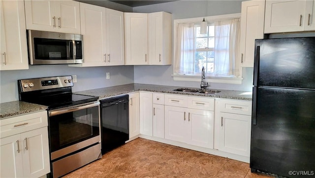 kitchen featuring stone counters, white cabinets, black appliances, and a sink