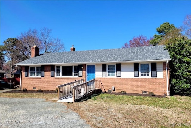 single story home featuring a front yard, a chimney, brick siding, and crawl space