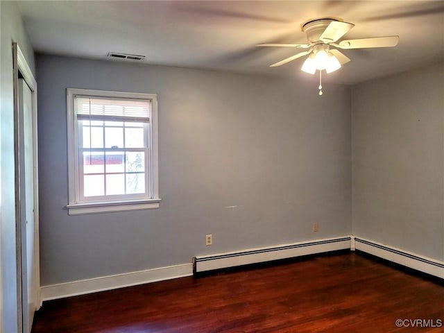 unfurnished room with a ceiling fan, wood finished floors, visible vents, baseboards, and baseboard heating