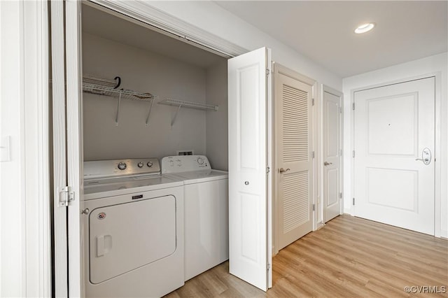 laundry room featuring light hardwood / wood-style floors and independent washer and dryer