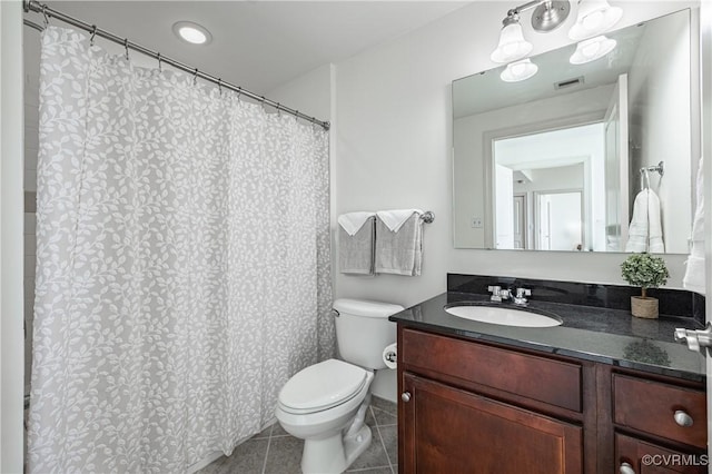 bathroom with tile patterned floors, vanity, and toilet